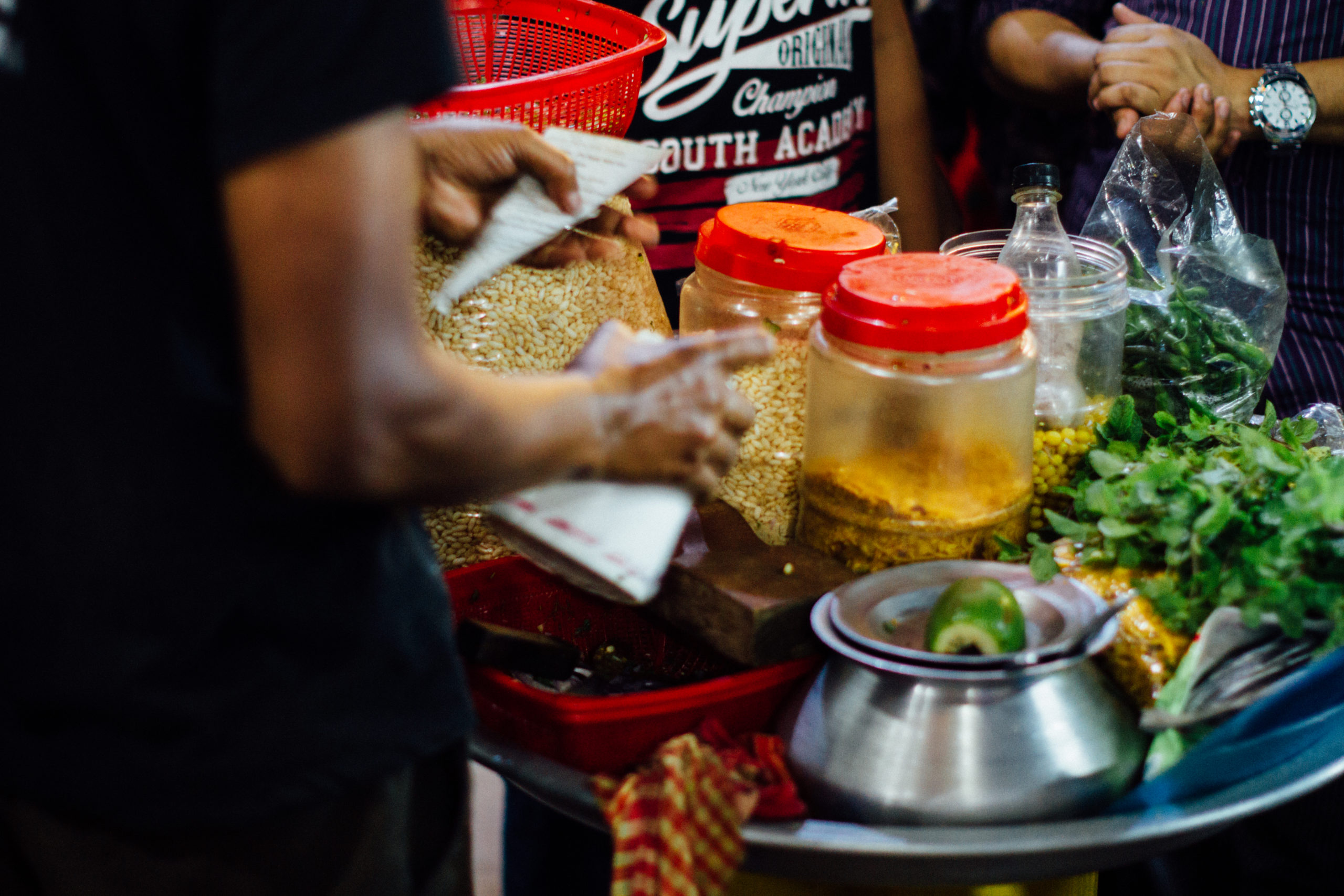 A street food vendor prepares ingredients at their stall in Chittagong, Bangladesh.